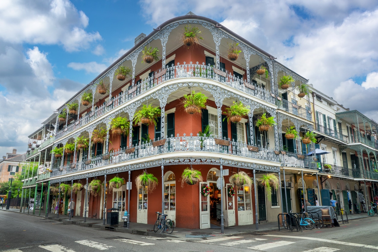 Historic French Quarter building with ornate iron balconies and hanging plants, New Orleans