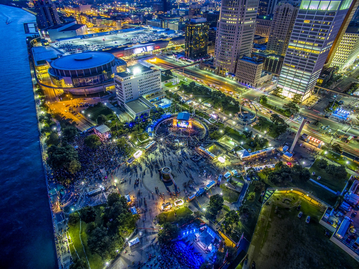 Panoramic Detroit skyline at dusk with Renaissance Center, downtown towers, and Huntington Place by the river