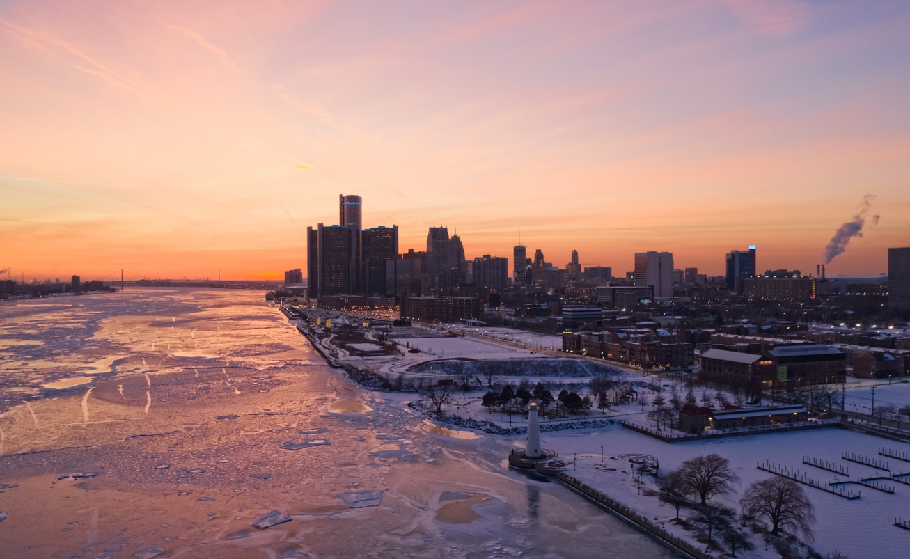 Snowy Detroit skyline and icy Detroit River at dusk