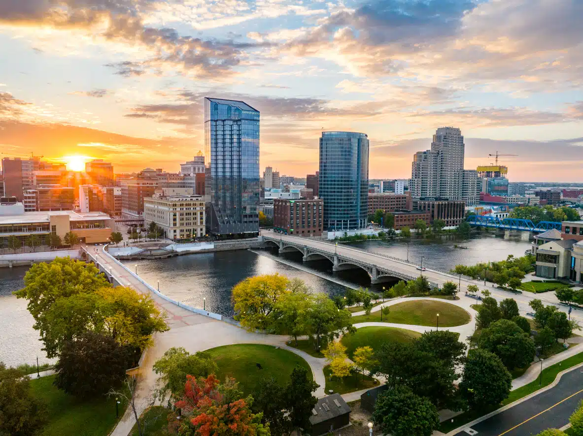 Grand Rapids skyline at sunset, a beautiful sight with the Grand River that awaits those moving to Michigan