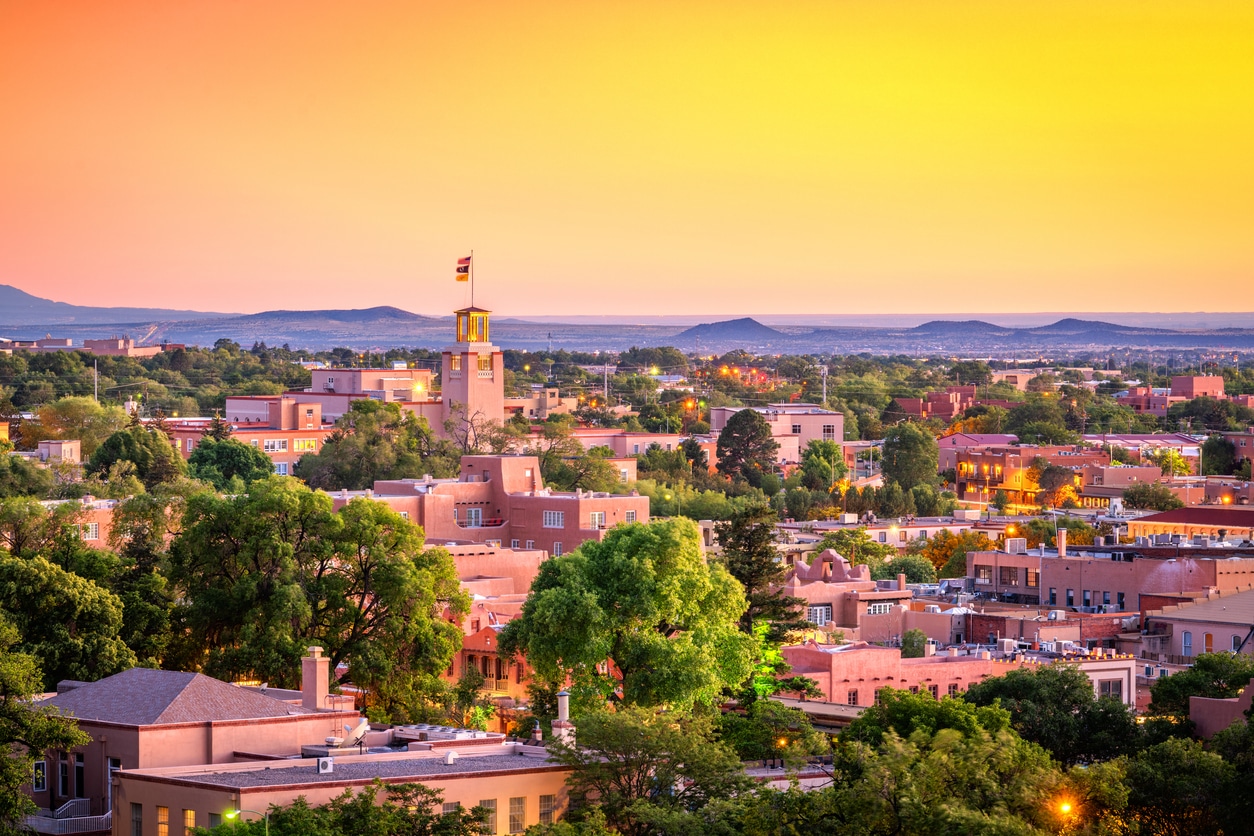 Sunset over adobe buildings in Santa Fe, New Mexico, reflecting the unique architecture and culture