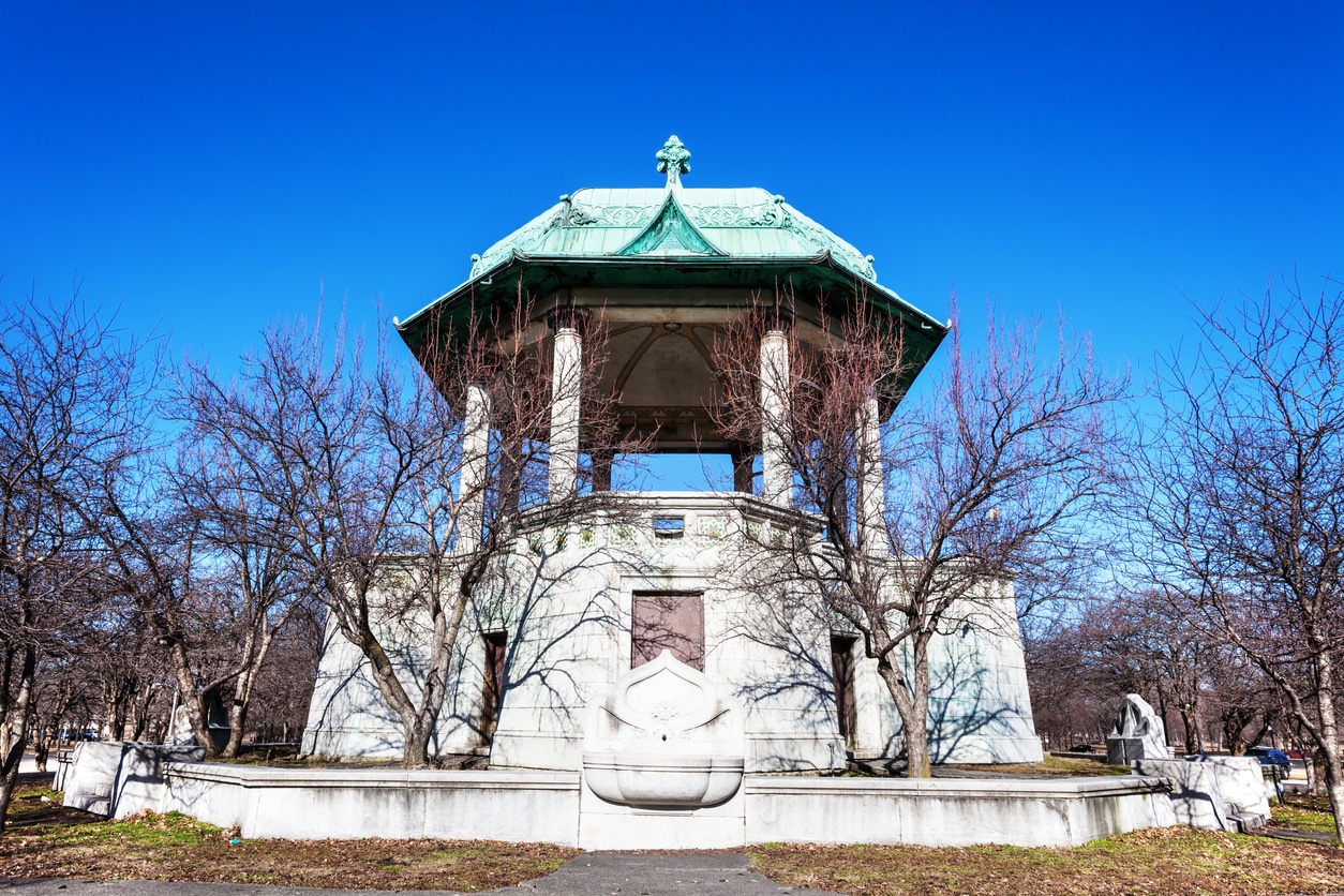 A historic stone bandstand in Garfield Park, Illinois, on a sunny day