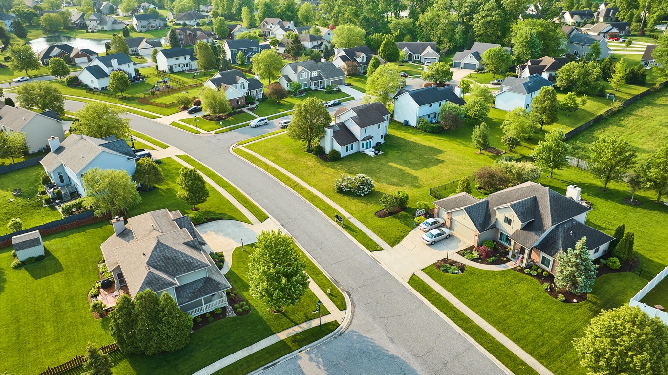 A peaceful aerial view of a sprawling residential neighborhood filled with houses and lush green lawns