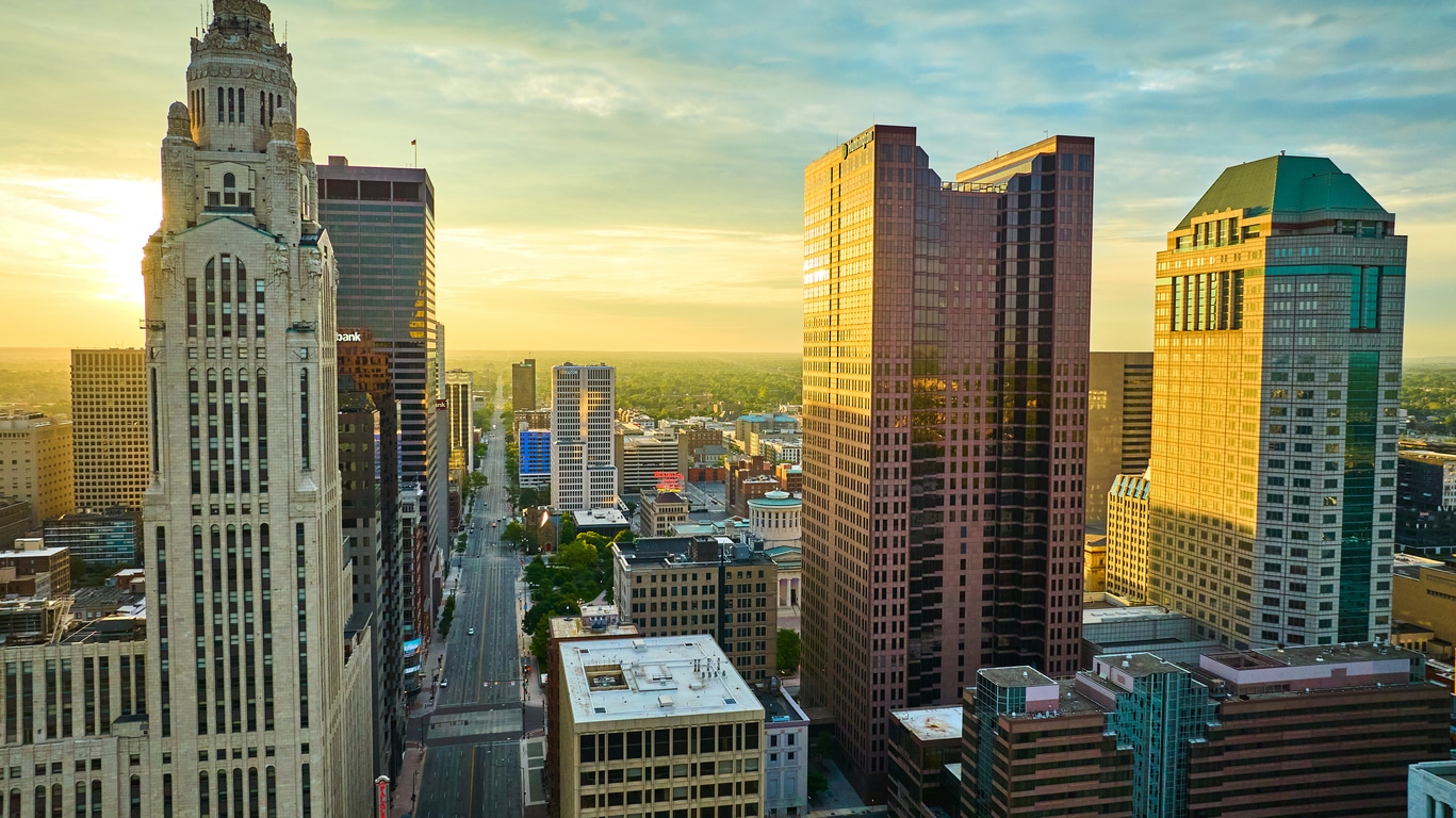 Aerial LeVeque Tower and Vern Riffe State Office Tower at sunrise with golden lighting Aerial view of a city street in Downtown Columbus, one of the best neighborhoods in Columbus for young professionals
