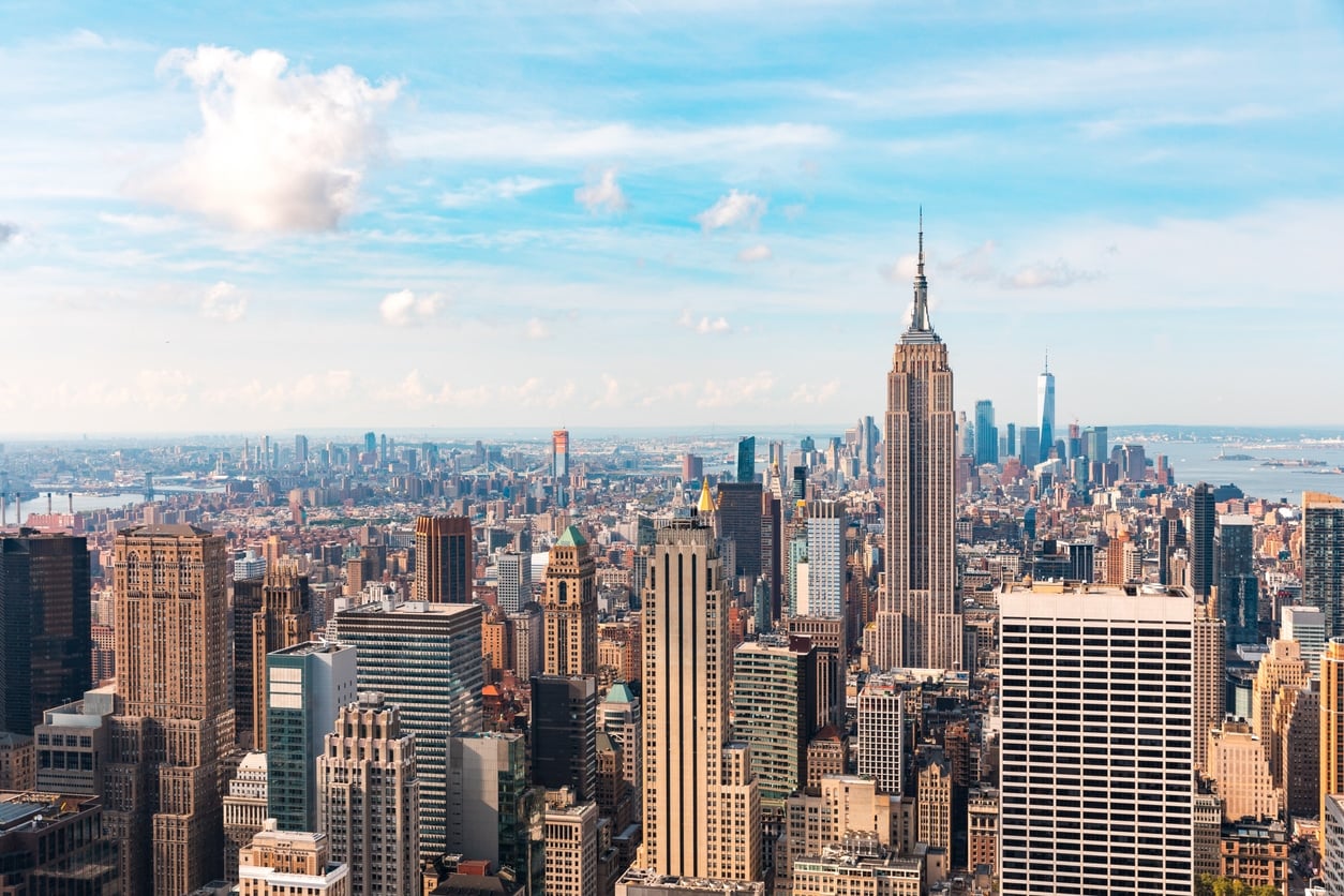 Wide aerial view of the New York City skyline, which greets those moving from Las Vegas to NYC