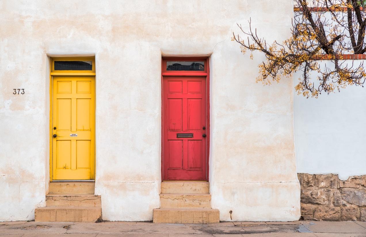 Red and yellow door on old building A vibrant yellow door and a red door side-by-side on a white stucco building in a Tucson, Arizona neighborhood