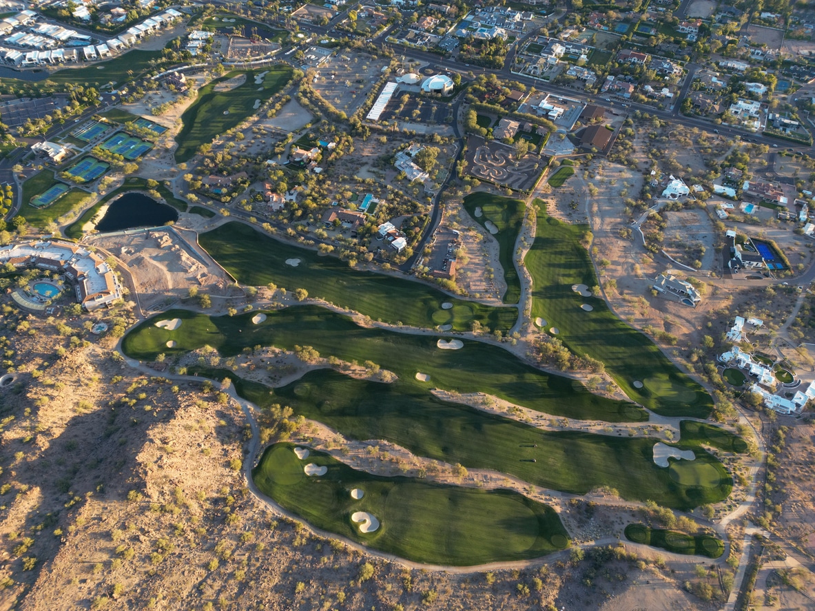 Aerial view of a lush green golf course winding through one of the best Scottsdale neighborhoods