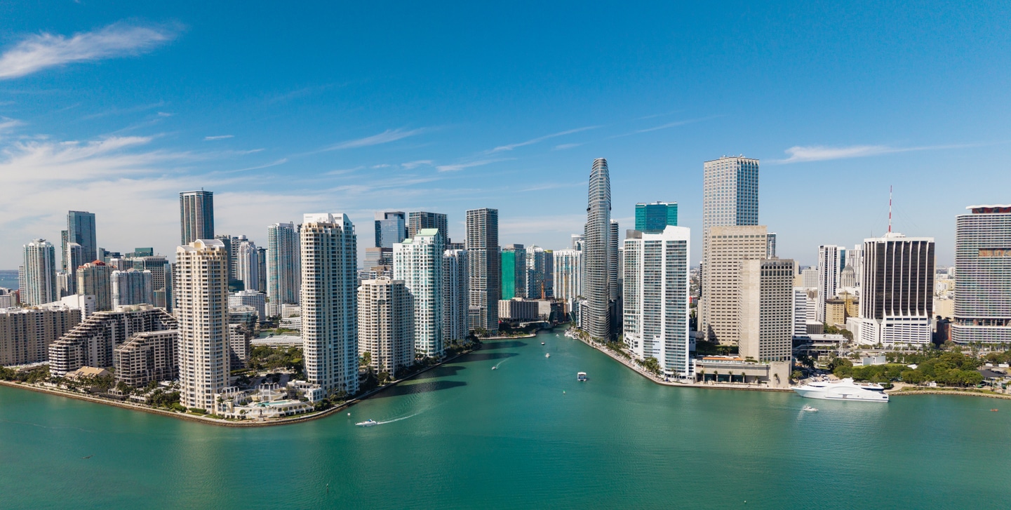 Aerial view of Miami, Florida, one of the best US cities for tech jobs, with high-rises along a turquoise waterway