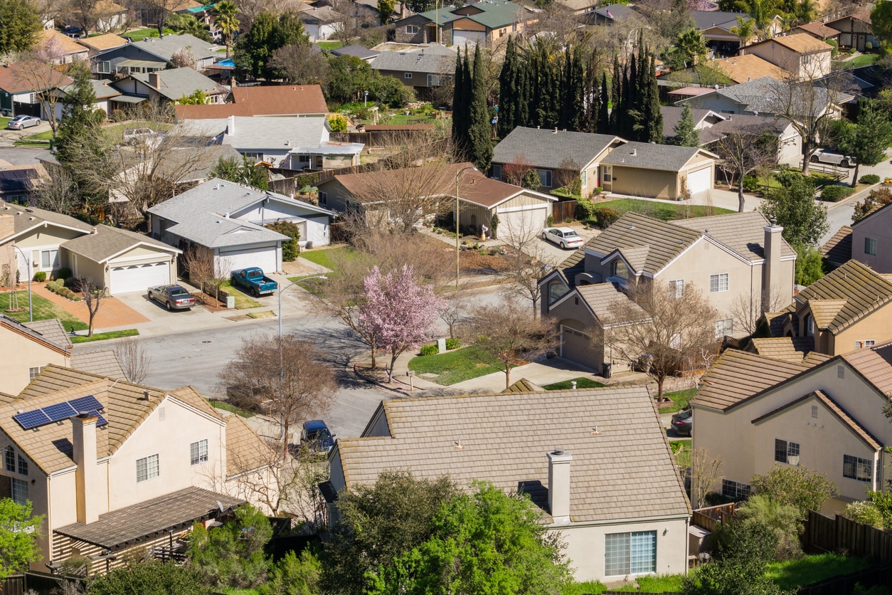 Aerial view of a San Jose neighborhood with suburban homes on a winding street with green lawns