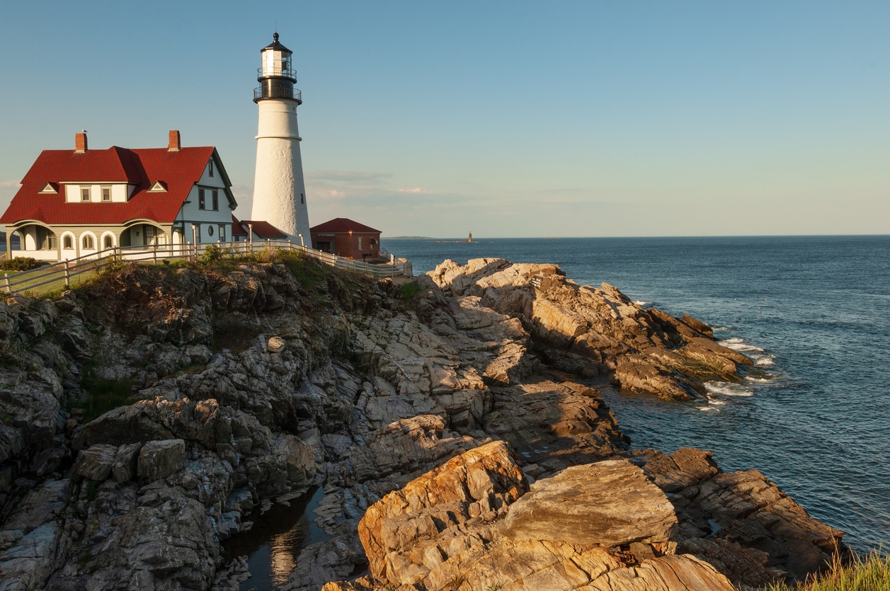 Portland Head Lighthouse A white historic lighthouse stands on a rocky coastline in one of the best places to live in New England