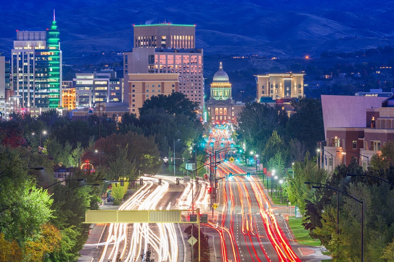 A night view of the Boise skyline with traffic light trails leading toward the illuminated Idaho State Capitol