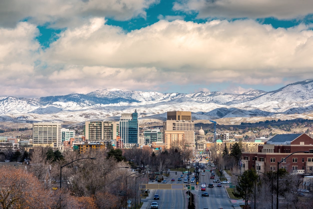  A city view of Boise, Idaho, with snow-covered mountains, showing what living in Boise is like during the winter