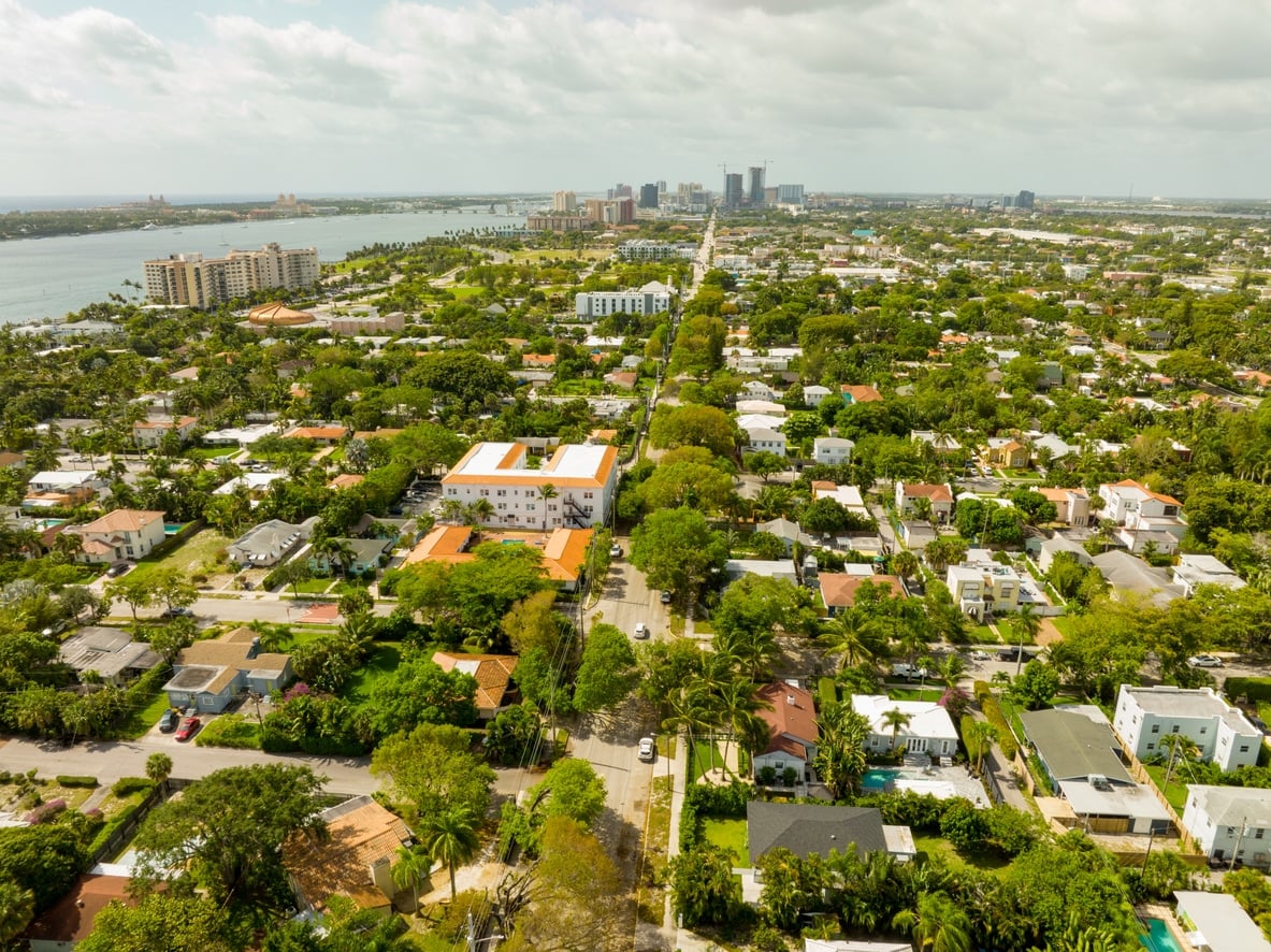 An aerial view of a sunny, tree-lined neighborhood, one of the best neighborhoods in West Palm Beach