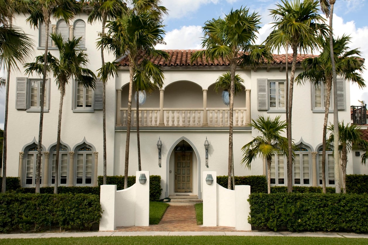 Mediterranean Revival style home exterior with stucco walls and a clay tile roof in West Palm Beach neighborhood